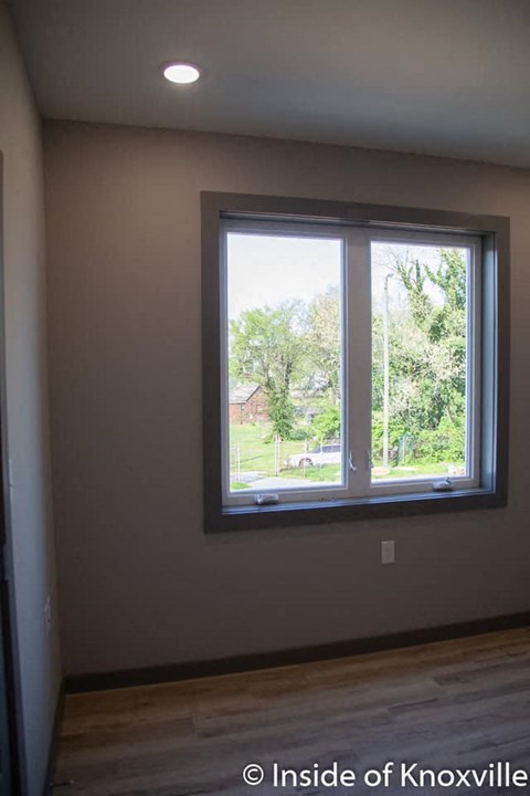 a large window in a room with a wooden floor
