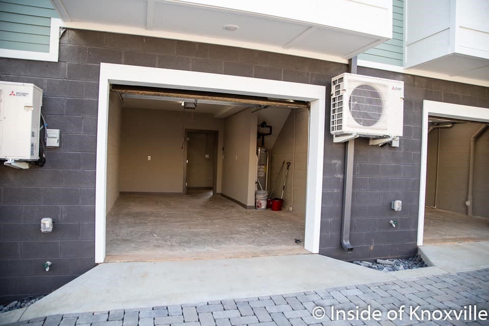 an empty garage with a air conditioner on the wall