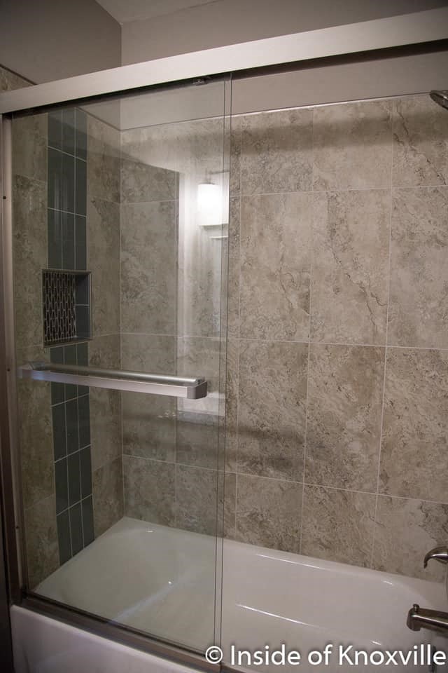 a bathroom with a shower with a glass door