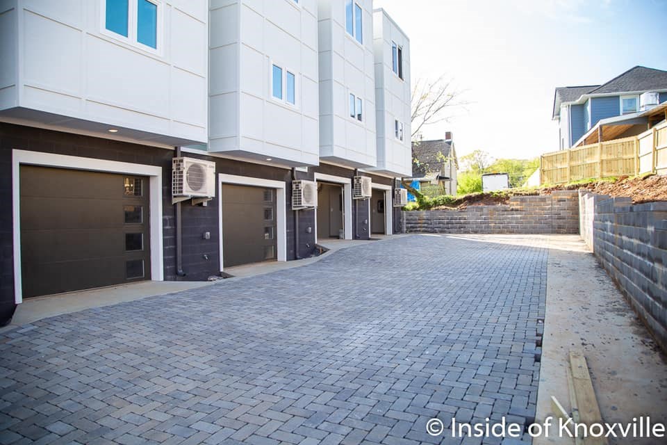 a cobblestone driveway in front of a building