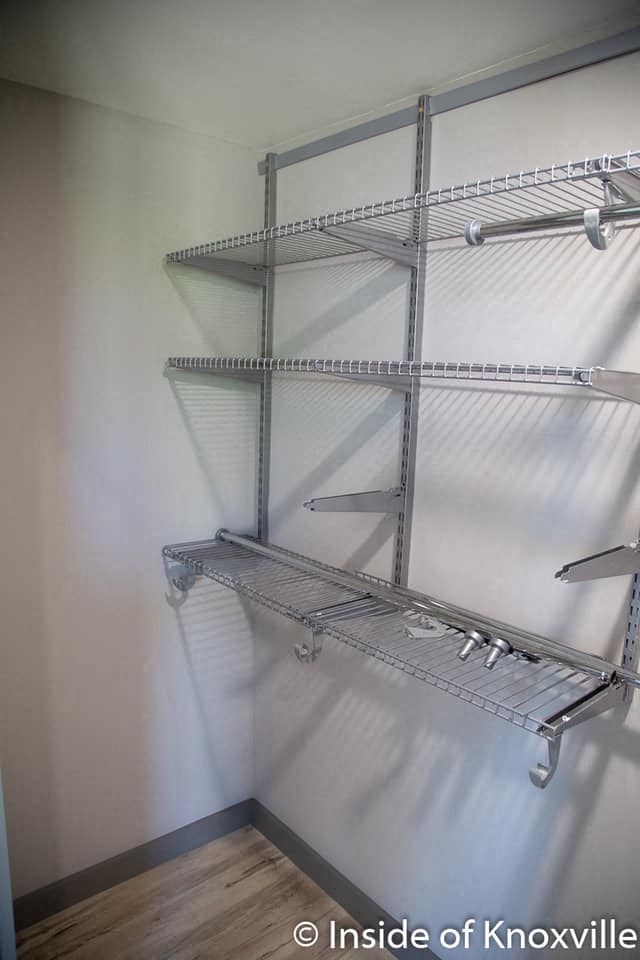 an empty closet with empty shelves on the wall