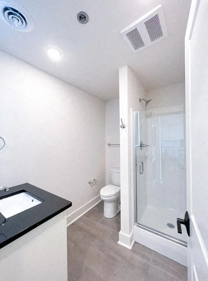 a bathroom with a toilet a sink and a shower