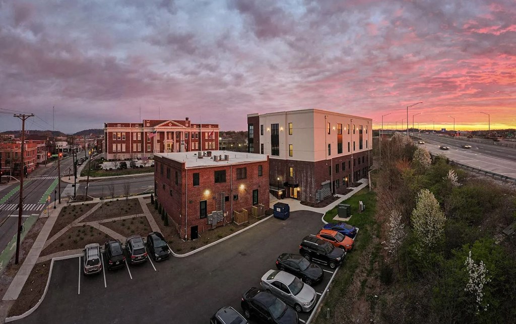 arial view of a building with cars parked in front of it