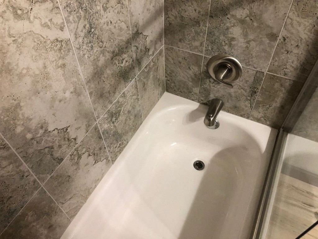 a bathroom with a shower and a sink