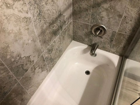 a bathroom with a shower and a sink