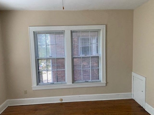 a room with a large window and a wooden floor