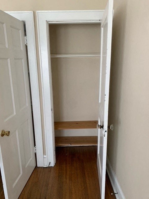 a closet with shelves and a white door