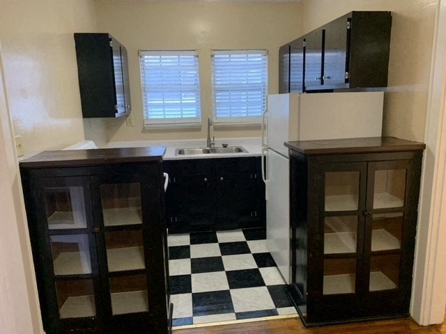 a kitchen with a checkered floor and black and white cabinets