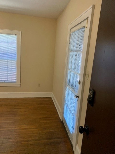 an empty room with a door and a window