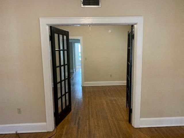 a living room with a door open to a hallway