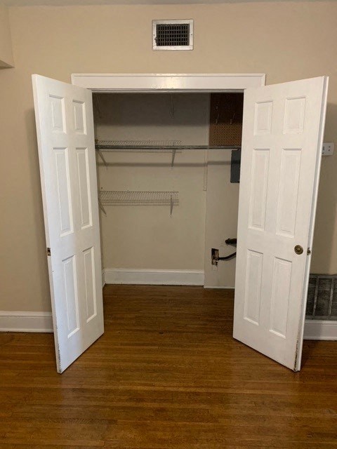 an empty room with a closet and an open door