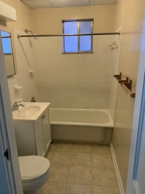 a small bathroom with a toilet and a tub and a sink