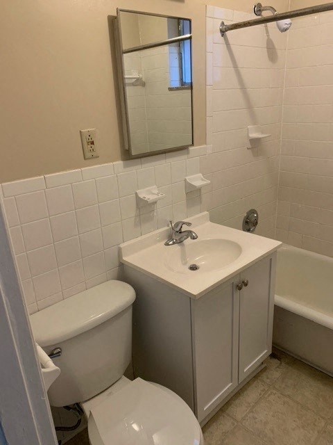 a bathroom with a toilet and a sink and a mirror