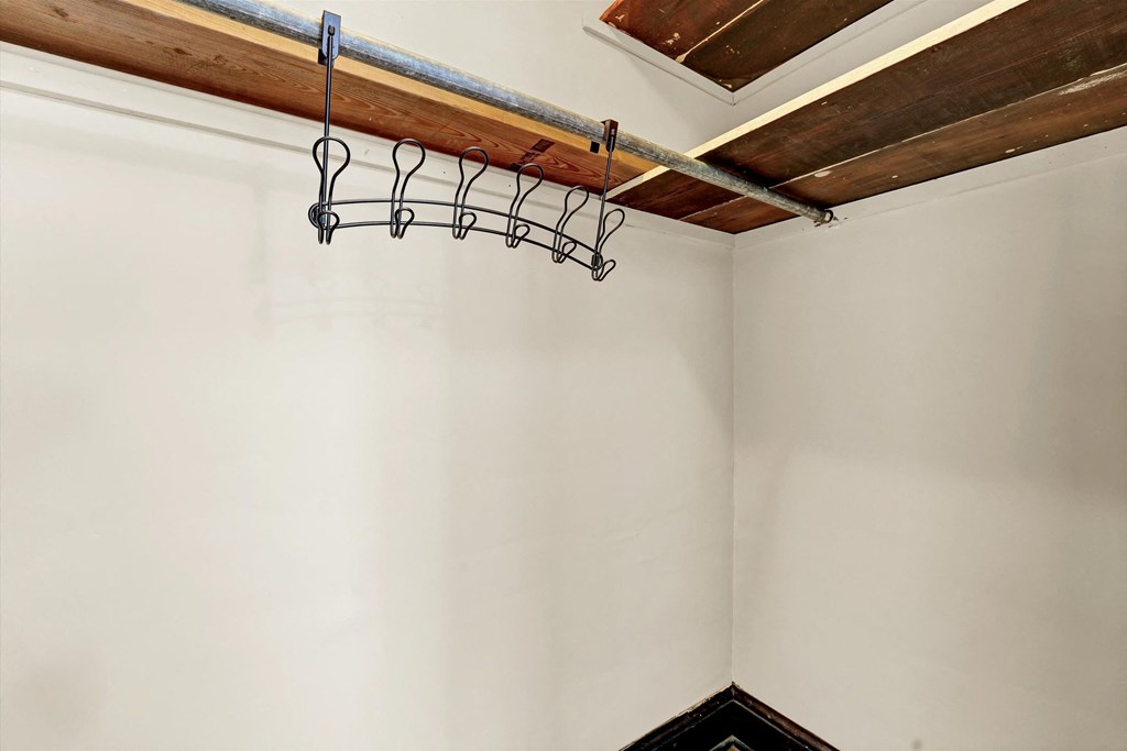 a corner of a room with a hanger on the wall