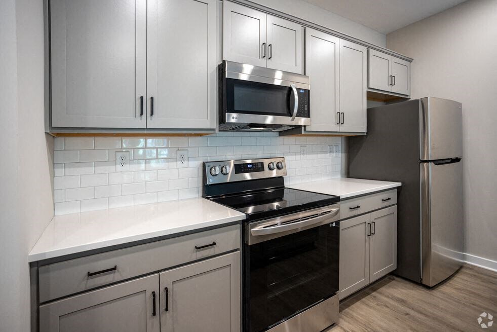 a kitchen with stainless steel appliances and white cabinets