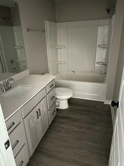 a white bathroom with a toilet and a sink
