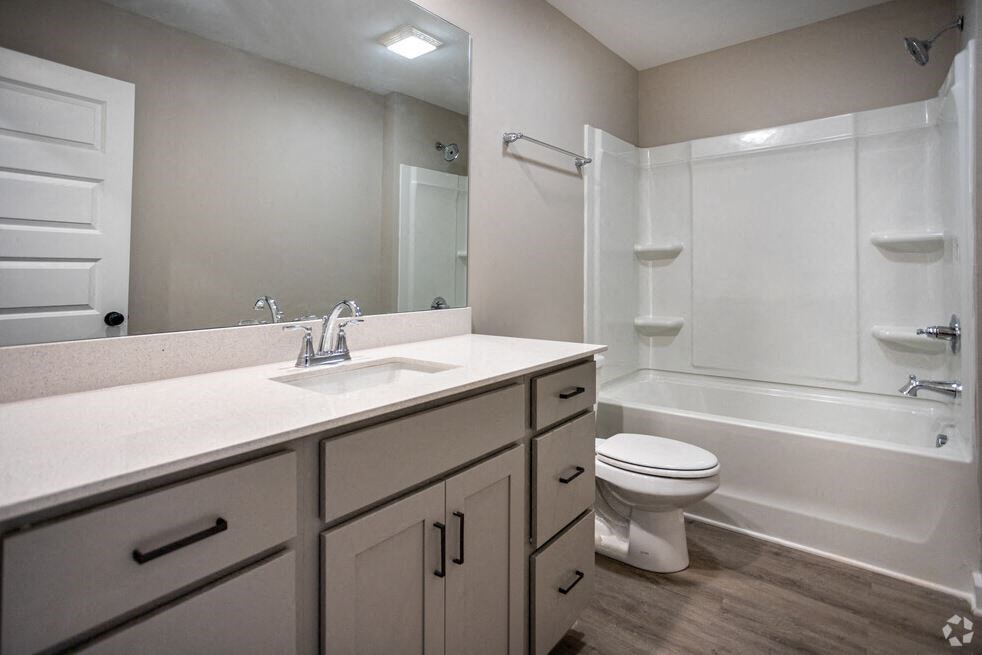a bathroom with a sink toilet and a mirror