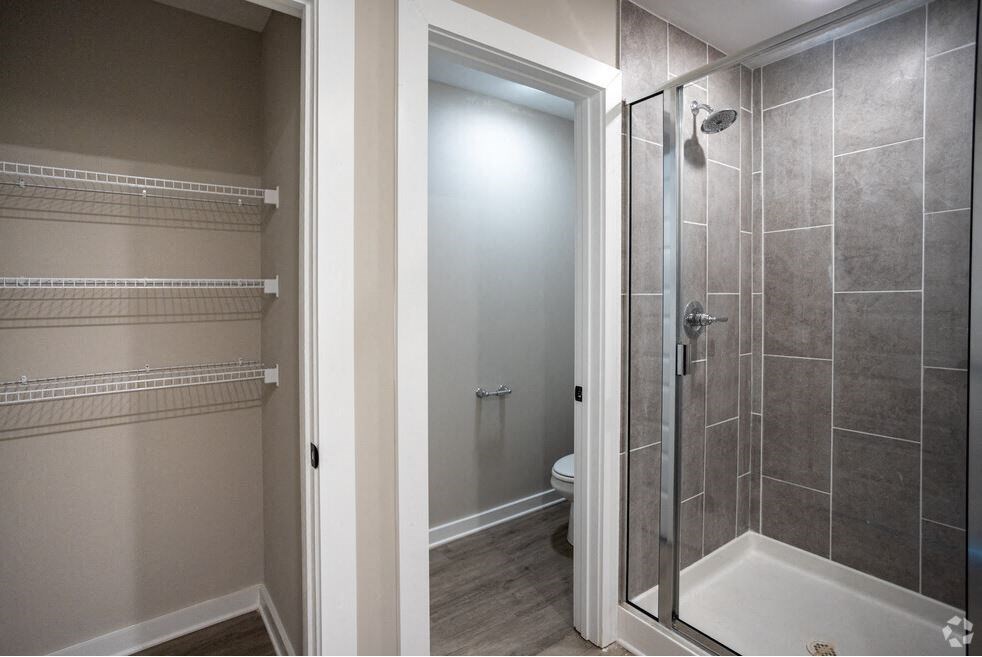 a bathroom with a shower and a toilet in it