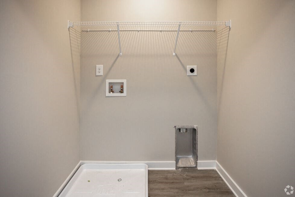a bathroom with a white tub and a wall with a shower