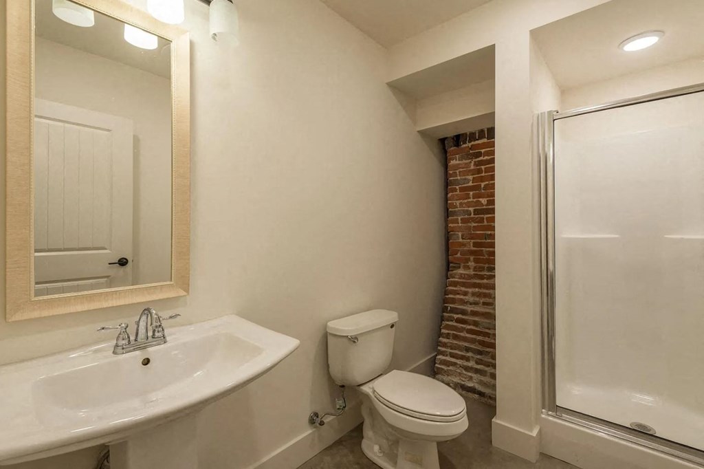 a bathroom with a toilet sink and shower