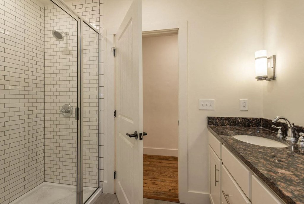 a bathroom with a shower and a sink