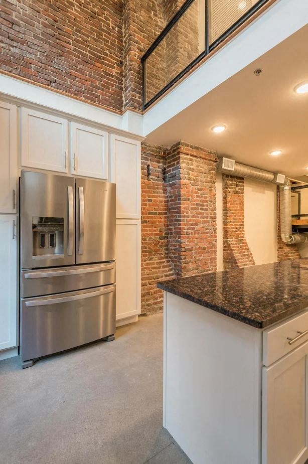 a kitchen with a large stainless steel refrigerator