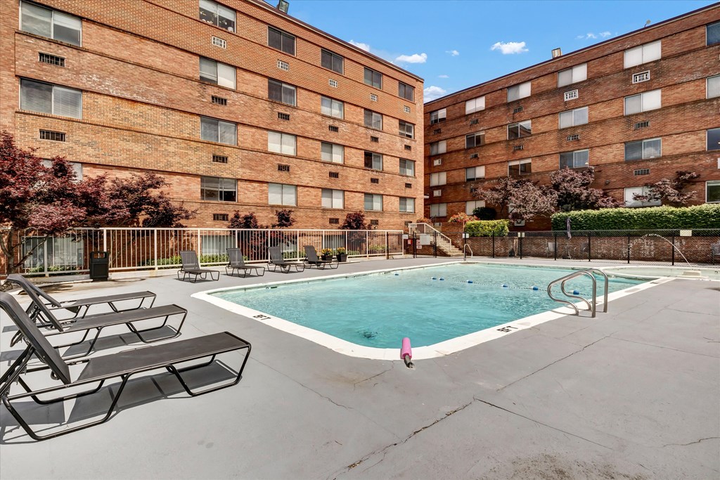 our apartments have a large swimming pool and a balcony with chairs