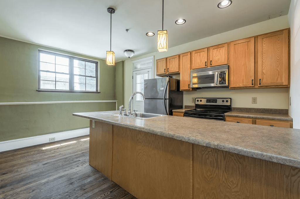 a kitchen with a large island with a sink and a stove