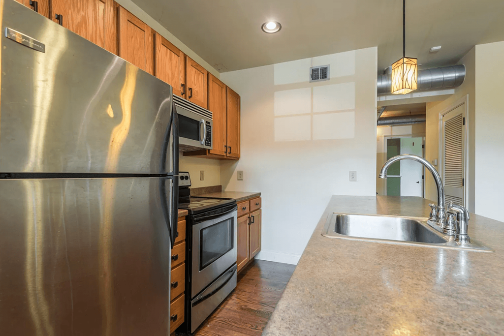a kitchen with stainless steel appliances and wooden cabinets