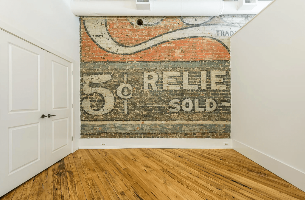 an old sign on a brick wall reads 5¢ relief sold