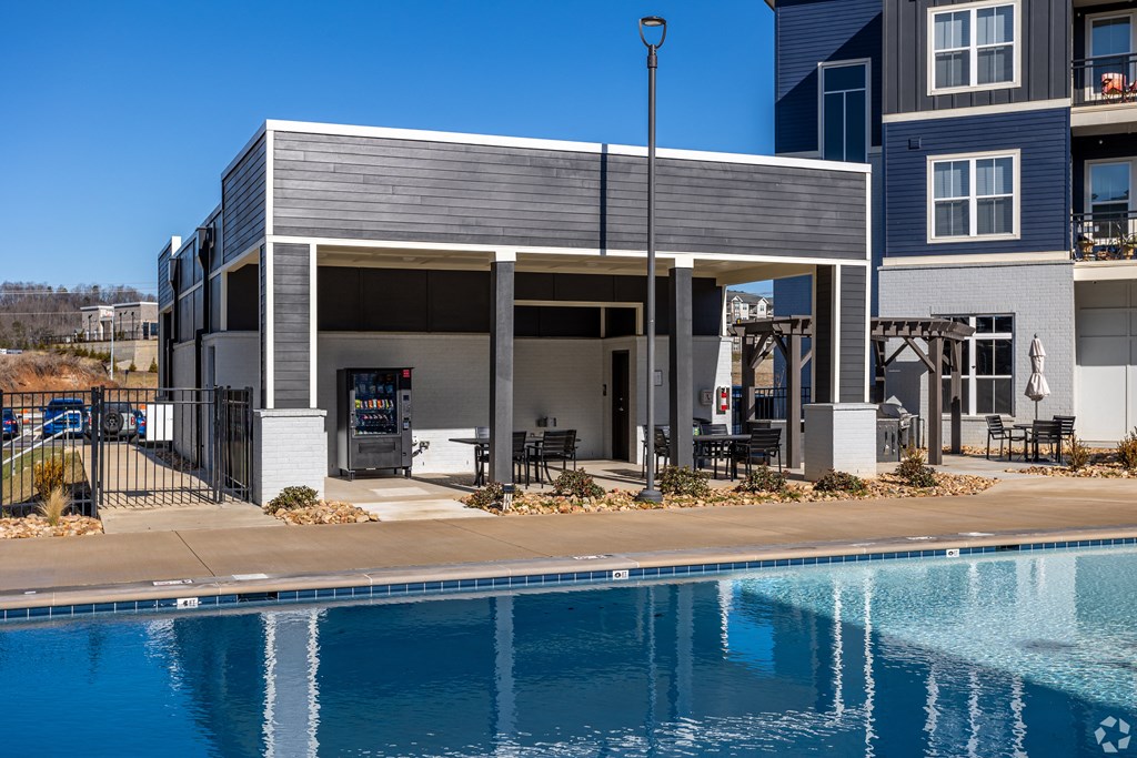 A modern house with a pool in front.