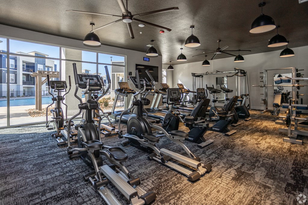 A gym with a variety of exercise equipment.