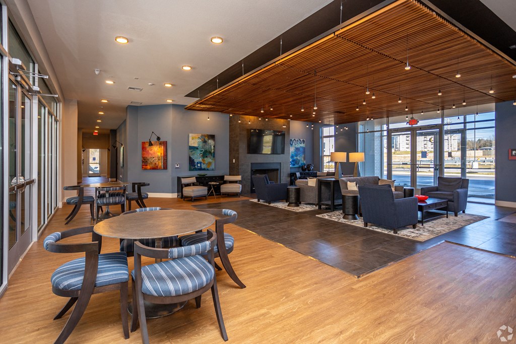 A large room with a wooden floor and a long table with chairs.
