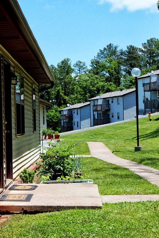 a house with a yard and a sidewalk in front of it