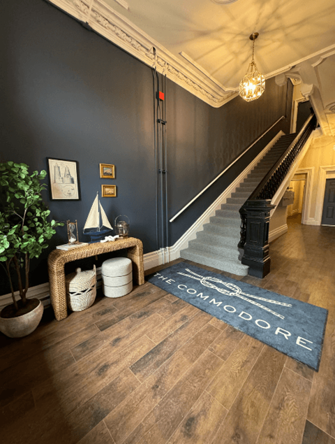 a rug that says come follow me on the stairs