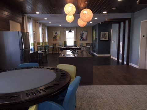 A dining room with a poker table and chairs.