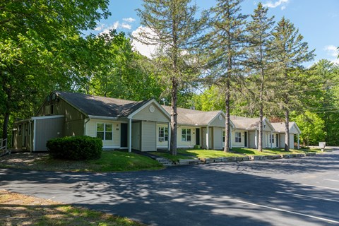 a row of houses on a tree lined street