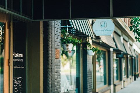 a city street with shops and a sign on a building