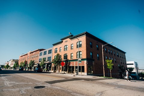 a large brick building on the corner of a city street