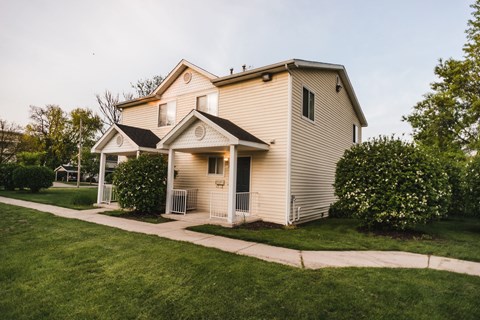a white house with a sidewalk in front of it