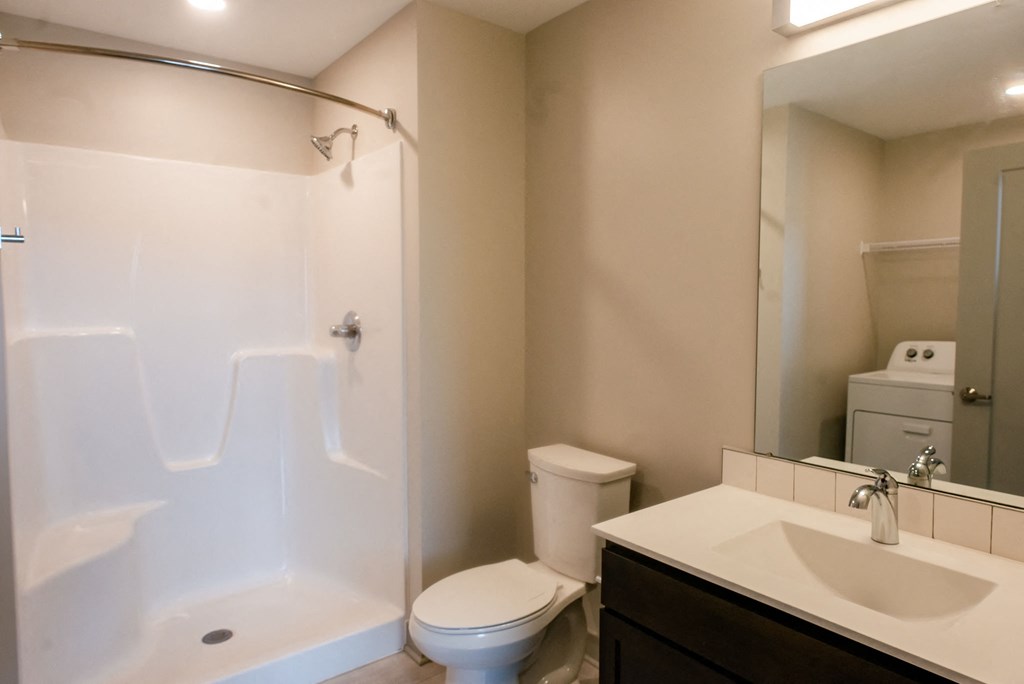modern bathroom with dark vanity and light countertop