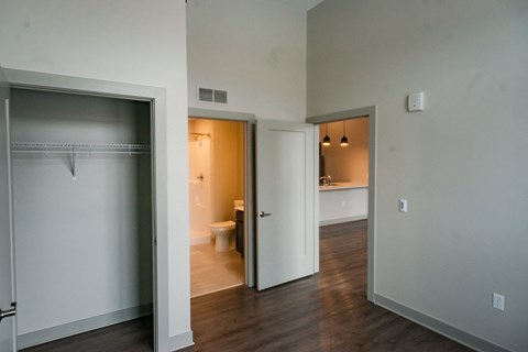 an empty living room with a door open to a bathroom