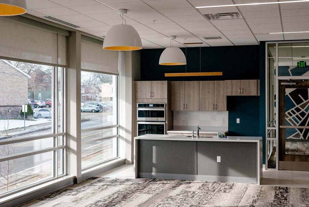 community room with modern kitchen and carpeting