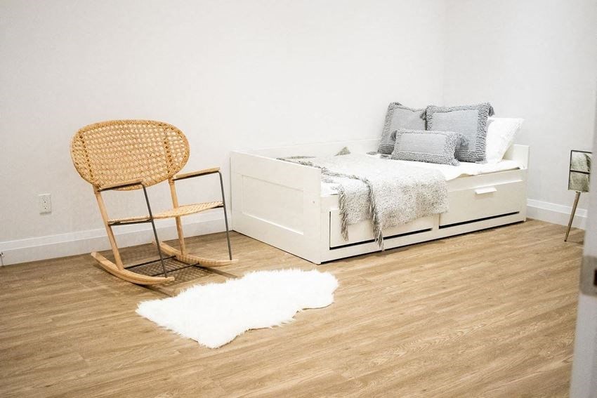 a bedroom with a bed and a rocking chair