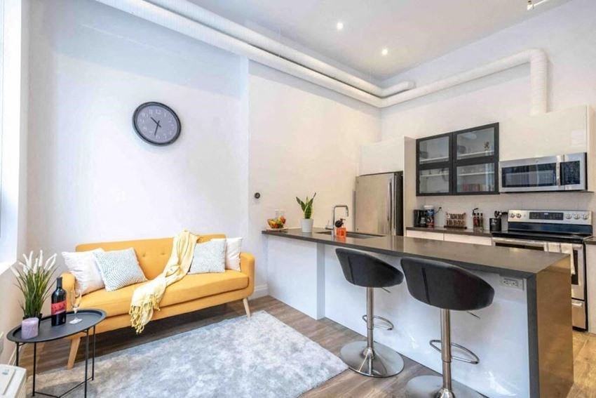 a living room with a kitchen and a couch