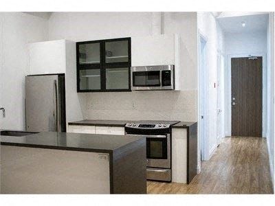 a kitchen with a stove and a refrigerator and a microwave