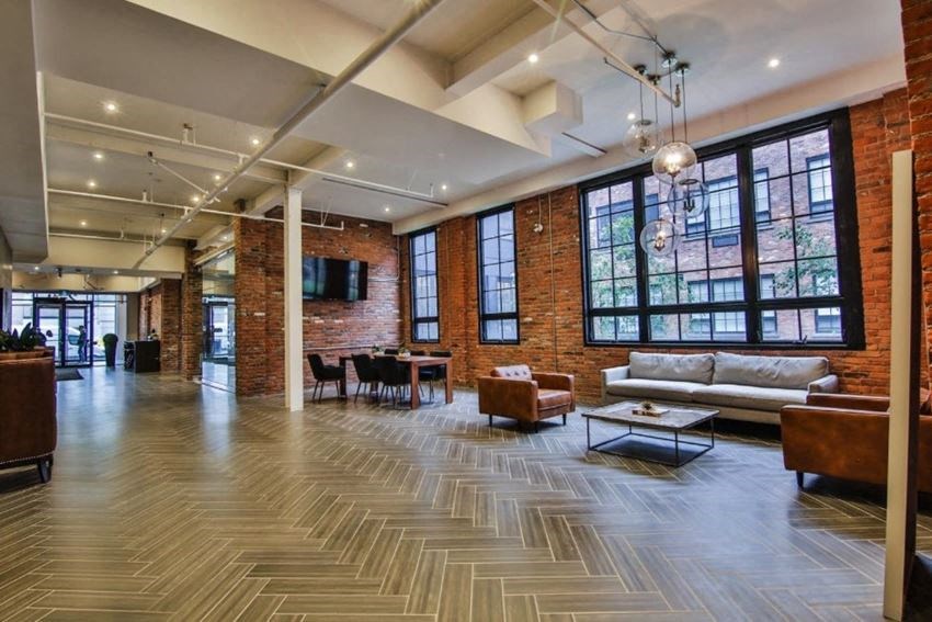 the lobby of a building with couches and a table