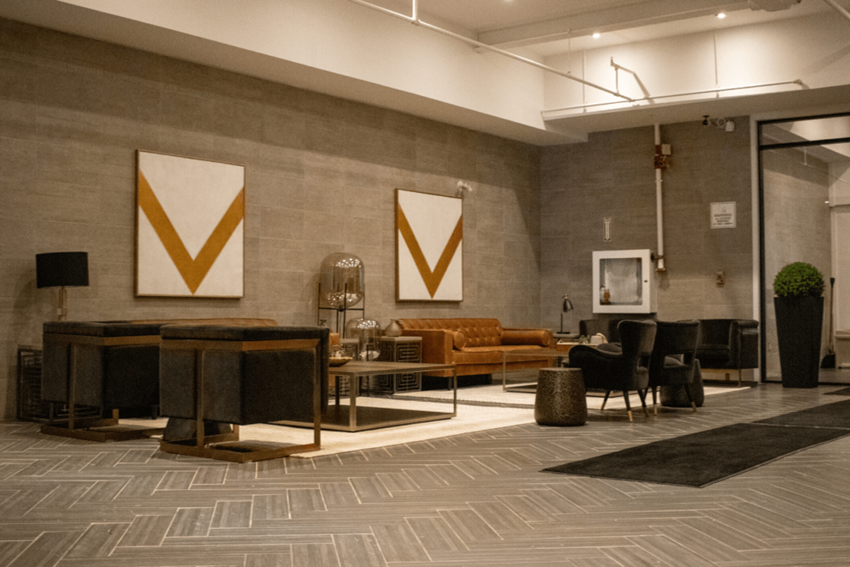 a lobby of a hotel with couches and chairs and a table