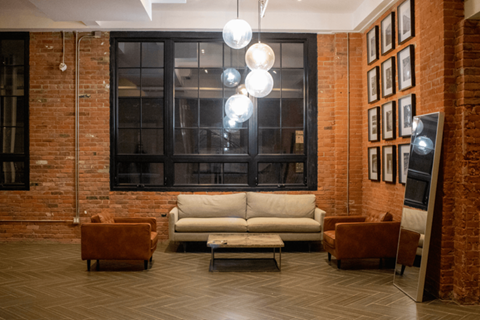 a living room with a couch and chairs in front of a window