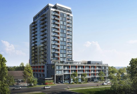 A modern multi-story apartment building overlooking a street.